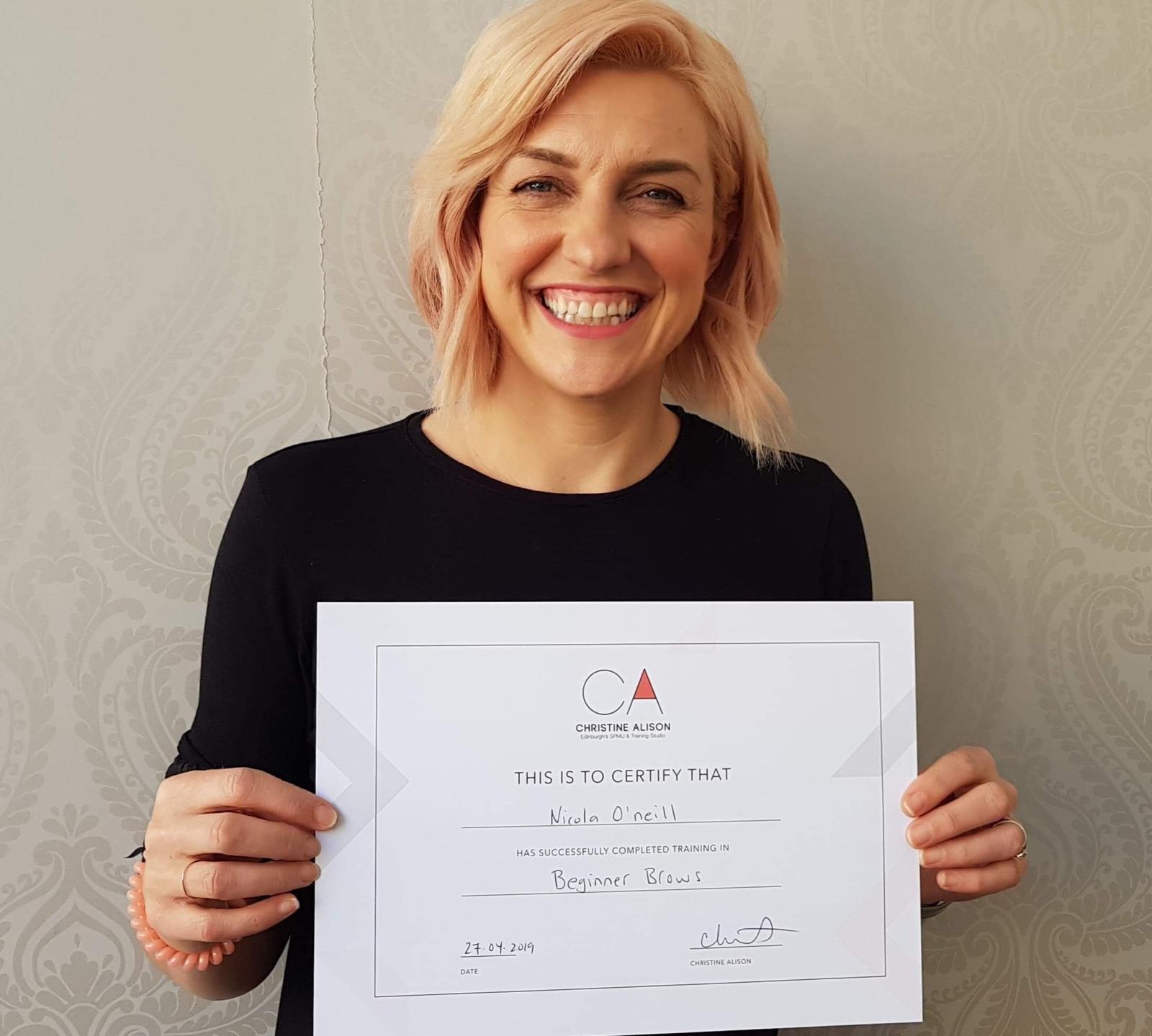 Nicola O’Neill holding her training certificate